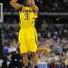 Michigan sophomore Trey Burke takes a three-point shot to tie the game and send it to overtime in the second half at Cowboys Stadium in Arlington, Texas on March 29, 2013. Melanie Maxwell I AnnArbor.com